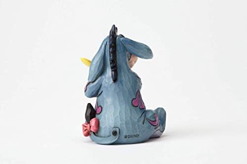 Enesco Disney tradicije Jima Shore Winnie Pooh Eeyore koji drži minijaturnu figuricu leptira, 3,125 inča, višebojan